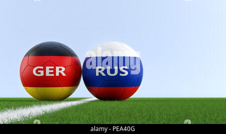 L'Allemagne contre la Russie Match de football - ballons de soccer en allemand et la Russie couleurs nationales sur un terrain de soccer. Copie de l'espace sur le côté droit - le rendu 3D Banque D'Images