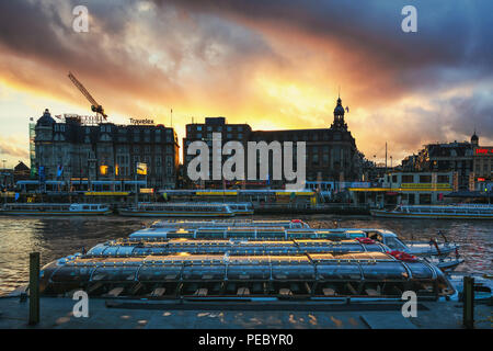 Amsterdam, Pays-Bas, le 26 décembre 2017 : bateaux du Canal à la station Place d'Amsterdam l'attendent les touristes. Banque D'Images