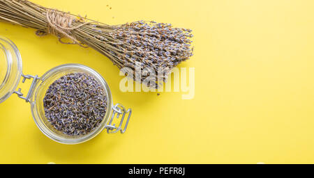 Concept d'herbes. Vue de dessus de lavande séchées bouquet sur table et fond jaune dans un bocal en verre. Banque D'Images