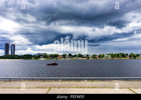 Petite embarcation flotte sur la Daugava avec les touristes avant la tempête Banque D'Images