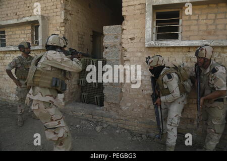 Soldats affectés à la 23e Brigade de l'armée iraquienne sécuriser un bâtiment en zone urbaine au Camp Taji, Iraq, 10 août 2015. Sous la supervision d'officiers iraquiens et de sous-officiers, soldats aiguisaient leurs tactiques d'opérations en zone urbaine avec une formation d'une semaine de l'exercice. Au cours de la formation participation leader démontre leur professionnalisme et inspirent la confiance de leurs soldats. Cela permet aux chefs des forces de sécurité iraquiennes pour définir les conditions pour continuer la lutte contre l'Etat islamique d'Irak et du Levant. (U.S. Photo de l'armée par la CPS. William Marlow/libérés) Banque D'Images