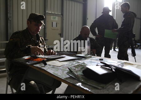 Un soldat allemand du 31e Régiment de parachutistes, 1e Brigade aéroportée donne sur une carte à l'intérieur du centre des opérations tactiques au cours de l'effort de réponse rapide à 15 l'armée américaine dans le centre de préparation interarmées multinationale Hohenfels, Allemagne, le 27 août, 2015. Le but de cet exercice est de mener des activités de formation conjointes et combinées afin d'évaluer le niveau de la brigade et du bataillon d'exécution out-stratégique en charge conjointement avec les pays partenaires par le biais d'une base d'étape intermédiaire. Réponse rapide 15 est le plus gros de l'armée américaine dans l'événement de formation combiné en Europe depuis la fin de la C Banque D'Images