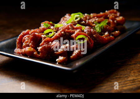 Marinade barbecue coréen raw beef Bulgogi en éclairage sombre moody Banque D'Images