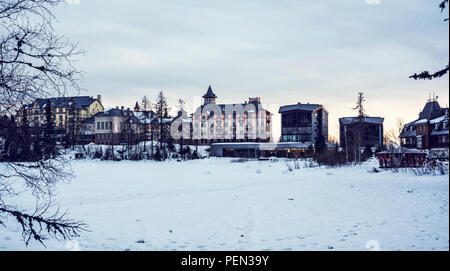 Hôtels en Strbske Pleso, Hautes Tatras, République Slovaque. Scène au coucher du soleil. Maison de vacances d'hiver. Destination de voyage. Blue photo filtre. Banque D'Images