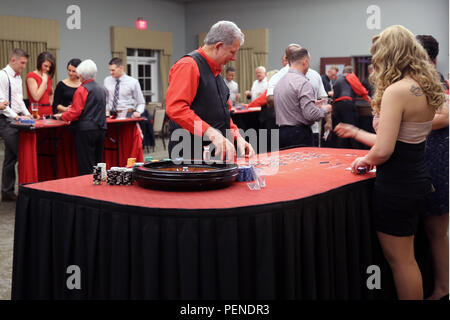 Les membres et les invités de service avec le Siège et l'Escadron placer des paris sur les jeux de casino différents au cours de l'escadron, Soirée casino annuel au Marine Corps Air Station Cherry Point, N.C., janv. 8, 2016. L'événement a donné les membres de service, les amis et les familles la possibilité de s'amuser et obtenir concurrentiel. Dès l'entrée à l'événement, chaque invité a été donné de faux billets qui ils ont tourné en aux revendeurs pour des jetons à jouer pour avoir une chance de gagner l'un des dizaines de prix de présence. Banque D'Images