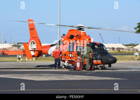 Le 17 janvier 2016, un hélicoptère MH-65 Dolphin de la Garde côtière s’est ravitaillé à Air Station Barbers point, Kapolei, Hawaï, alors qu’il effectuait des opérations de recherche et de sauvetage pour les survivants d’un écrasement d’hélicoptère CH-53E Super Stallion sur la rive nord d’Oahu. Le MH-65, propulsé par deux turbomoteurs, offre des capacités de recherche maritime à réponse rapide. La mission comprenait la coordination avec les coupeurs et le personnel de la Garde côtière pour localiser les Marines manquants et évaluer les débris accidentés. Banque D'Images