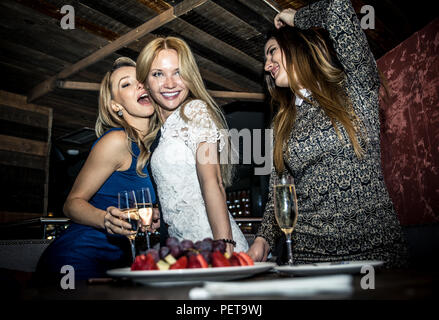 Filles de partie dans un restaurant célèbre avec boissons et champagne Banque D'Images