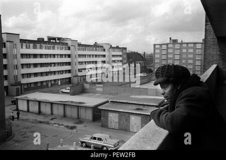 Pauvreté des années 1970 en Grande-Bretagne, une femme britannique noire âgée dans son balcon plat du domaine du conseil sur le domaine de Stonebridge. Isolé et vivant seul dans une chambre individuelle plus petite cuisine et salle de bains. Le tout en très mauvais état, l'appartement est humide et très froid. Haggerston, East London, Angleterre 1978. HOMER SYKES des années 70 Banque D'Images