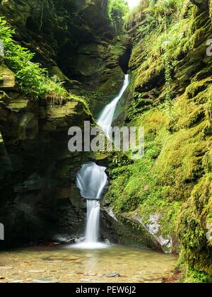 Une cascade à travers un trou dans la roche à St Nectan's Glen à Cornwall Banque D'Images