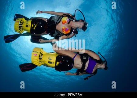 Deux femmes plongeuses (MR) sur les scooters sous-marins, à Hawaï. Banque D'Images