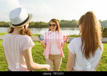 L'heureuse mère est activement en appui sur la nature avec ses filles adolescentes 14 à 16 ans. La communication des parents et adolescents, Femme avec summ Banque D'Images