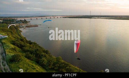 Paramoteur vol silhouette sur la rivière et sunset sky Banque D'Images