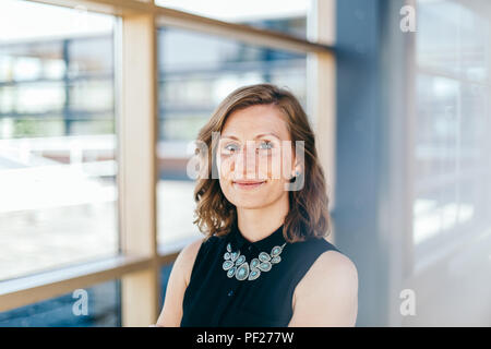 La confiance des entreprises et élégante femme sourit à l'appareil photo Banque D'Images