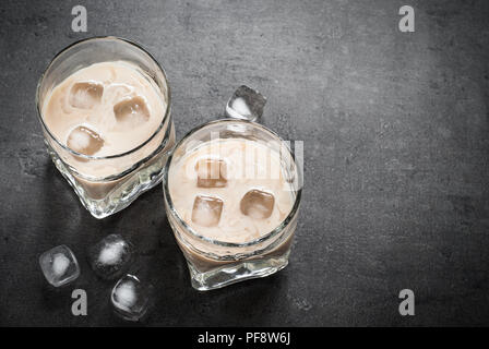 Boisson à la crème irlandaise dans les verres avec de la glace sur le noir. Banque D'Images