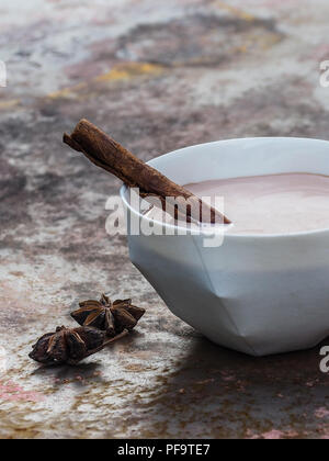 Thé chai latte fait maison avec le bâton de cannelle. Banque D'Images