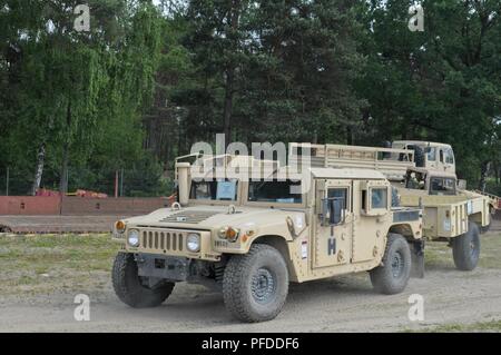 Soldats, affectés au quartier général de l'entreprise et de l'Administration centrale, 91e bataillon du génie de la Brigade (BEB), 1st Armored Brigade Combat Team (ABCT), 1re Division de cavalerie (CD), le déchargement des véhicules de Zagan, Pologne, le 4 juin 2018. L'accueil de ces véhicules s'assure 91e BEB, 1er ABCT, 1er CD's de préparation aux missions à l'appui de la résolution de l'Atlantique, un exercice d'entraînement durables entre l'OTAN et des Forces américaines. Banque D'Images