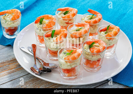 Les Crevettes cocktail délicieux avec les tireurs de mayonnaise sauce épicée décoré de feuilles de persil sur le plateau blanc sur tapis de table au Festi Banque D'Images