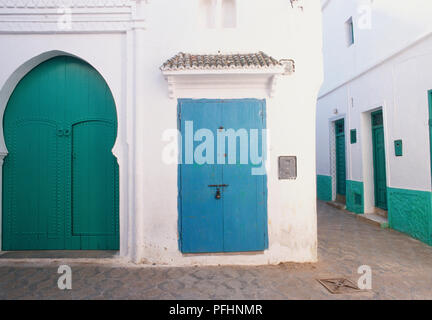 Le Maroc, Asilah, portes peintes de couleurs vives des bâtiments dans les rues étroites de la médina. Banque D'Images