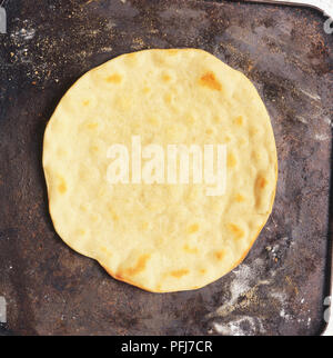 Crêpe ronde et plate-comme le pain blanc, cuit sur une plaque chauffante. Banque D'Images