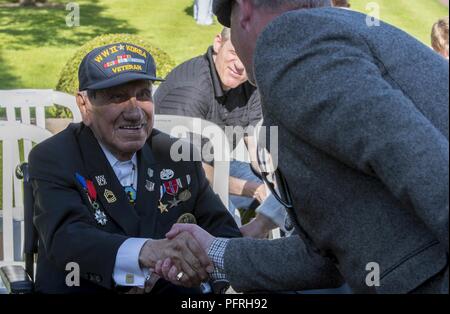 Normandie, France (27 mai 2018) Guerre mondiale Deux PFC. Charles Shay, 16e Régiment d'infanterie, 1re Division d'infanterie, répond aux personnes qui assistent à une journée du souvenir et de la Première Guerre mondiale, la cérémonie de commémoration du centenaire au cimetière américain de Normandie, France, le 27 mai 2018. Les Forces navales des États-Unis, dont le siège social est situé à Europe-afrique, Naples, Italie, supervise les opérations navales et mixte, souvent de concert avec les pays alliés et partenaires interinstitutions, pour permettre des relations durables et d'augmenter la vigilance et la résistance à l'Europe et l'Afrique. Banque D'Images