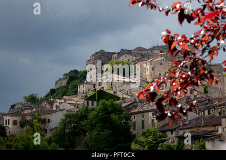 Ciel et nuages sombres tonitruant avec la lumière du soleil illumine le village médiéval de Cordes-sur-Ciel, Tarn, Occitanie, France, Europe, en été Banque D'Images