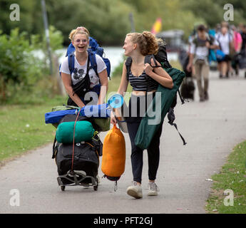 Les festivaliers à pied le long du chemin de halage de la Tamise à mesure qu'ils arrivent pour la lecture Festival à Richfield Avenue, Reading, Berkshire, qui commence le vendredi. Banque D'Images