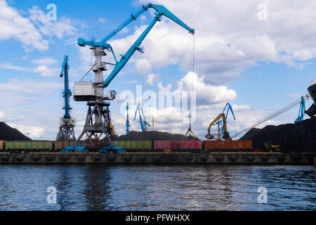 Grand cargo rouge avec un chargement de charbon dans le port, terminal, d'une grue, d'un conteneur Banque D'Images