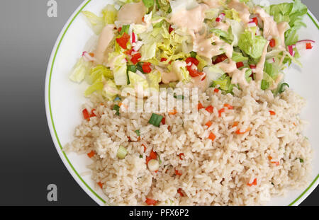 Repas sain, de farine de riz brun aux légumes et une salade du jardin frais surmonté d'une vinaigrette crémeuse Banque D'Images