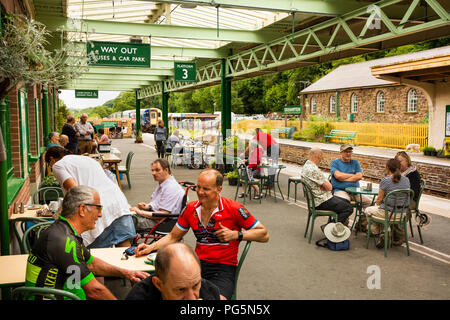 Royaume-uni, Angleterre, Devon, Okehampton, gare, les passagers à buffet tables sur la plate-forme Banque D'Images