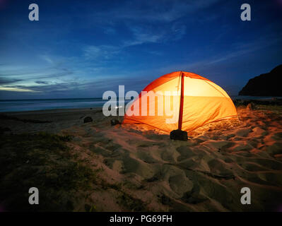 USA, Hawaii, Kauai, Polihale State Park, éclairé tente sur la plage la nuit Banque D'Images