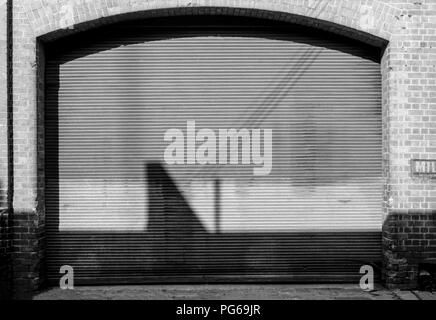 Un groupe d'ombre : reflète les formes sur une porte de garage. Banque D'Images