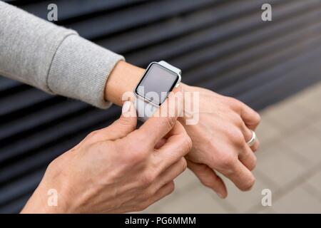 Woman's hand le réglage des paramètres de smartwatch, close-up Banque D'Images