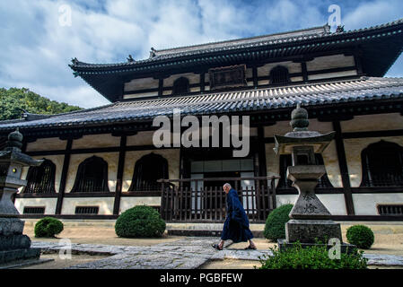 Okayama, Japon: Le moine bouddhiste marche devant si le temple bouddhiste avant la cérémonie. Okayama, Japon Banque D'Images