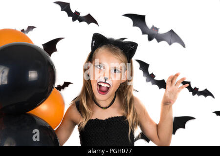 Smiley fille avec chat noir halloween, costume et maquillage noir et l'orange de ballons à halloween, citrouille. Halloween kids. Banque D'Images