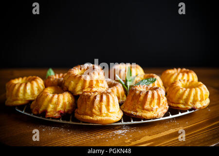 Muffin sucré en poudre sucre en grains sur la table en bois Banque D'Images