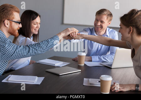 Les travailleurs excités inscrivez-vous mains engagés dans l'activité de teambuilding Banque D'Images