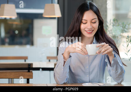 Femme de boire du café au café Banque D'Images