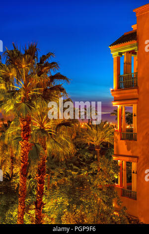 Marrakech Maroc hotel de luxe d'un balcon et jardin oasis palm dans la nuit avec un paysage spectaculaire de l'éclairage. Ciel bleu profond. Les couleurs du Maroc. Banque D'Images