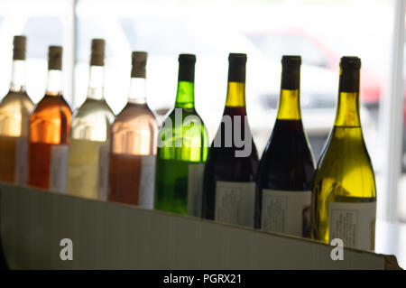 Une rangée de bouteilles de vin de couleur naturel blanc lumineux par contre un fond clair Banque D'Images