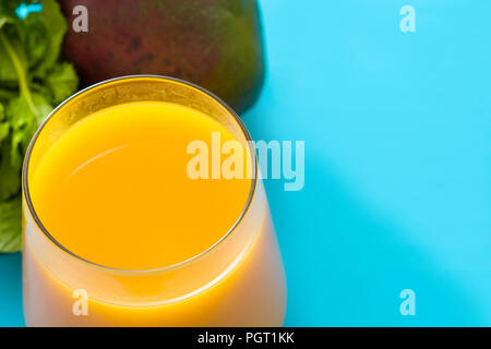 Lassi à la mangue dessert. Boisson traditionnelle indienne sur fond bleu. Copyspace Banque D'Images
