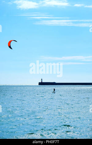 Le phare du port de Newhaven et mur sont au milieu d'une mer soleil bleu au premier plan et le bleu et les nuages blancs dans l'arrière-plan vertic Banque D'Images