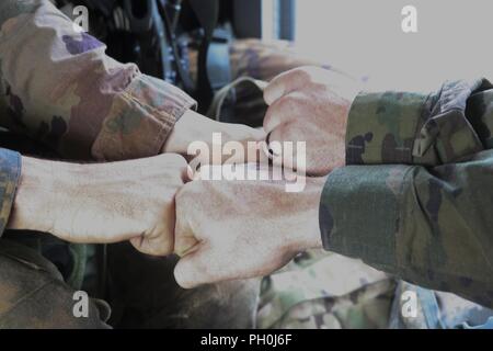 Des soldats de la réserve de l'Armée américaine à féliciter les uns les autres pendant le vol de retour dans un hélicoptère de la dernières activités de la réserve de l'armée américaine 2018 Concours meilleur guerrier à Fort Bragg, Caroline du Nord, le 14 juin 2018. Lorsque tous les résultats ont été calculés et les concurrents ont reposé après la compétition exténuante, les Forces armées allemandes Badge de compétence, l'excellence en compétition pistolet de badge et l'armée américaine Réserver 2018 Meilleurs sous-officiers et soldats du guerrier titres soldat sont attribués. Banque D'Images