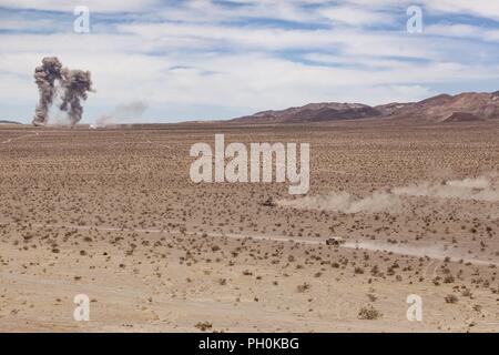 U.S. Marine Corps M1A1 Abrams Chars de bataille avec Compagnie E, 4e Bataillon, 4e Division de marines, d'attaque vers l'objectif dans le cadre d'un cours d'assaut mécanisé réservoir intégré au cours de l'exercice Formation 4-18 au Marine Corps Air Ground Combat Center Twentynine Palms, Californie, le 15 juin 2018. L'ITX 4-18 fournit sur la masse de l'air les éléments de la Force opérationnelle l'occasion de subir une évaluation de niveau de service des compétences de base qui sont essentielles à l'avant-corps expéditionnaire, les opérations de déploiement. Banque D'Images