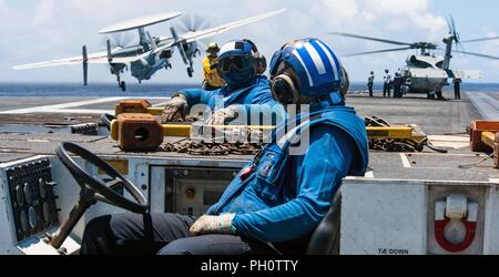 Mer des Philippines (19 juin 2018) observer les marins les opérations de vol comme un E-2D Hawkeye affectés à l'Escadron d'alerte aéroporté (VFF) 125 lance sur le poste de pilotage de la Marine a déployé des porte-avions USS Ronald Reagan (CVN 76). Ronald Reagan, le navire amiral de Carrier Strike Group (CSG) 5, fournit une force prête au combat qui protège et défend les intérêts de maritime collective de ses alliés et partenaires dans la région Indo-Pacifique. Banque D'Images
