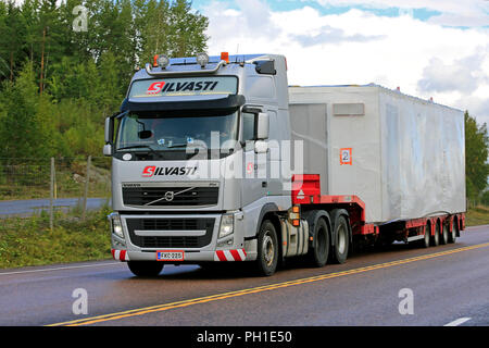 Mikkeli, Finlande - le 27 août 2018 : Volvo FH semi-remorque de transport lourd Silvasti chalet transportable le long de la route 9 sur l'image de la fin de l'été. Banque D'Images