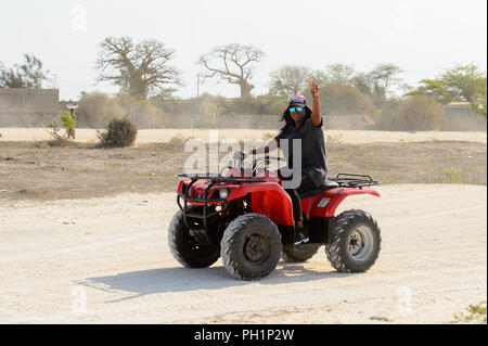LAC ROSE, AU SÉNÉGAL - Apr 26, 2017 : Un homme monte un quad sur la côte du lac salé Lac Retba, Site du patrimoine mondial de l'UNESCO Banque D'Images