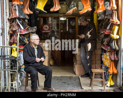 ISTANBUL, TURQUIE - 28 décembre 2015 : deux chaussures vendeur près du marché aux épices se reposant devant leur boutique, sur le côté européen d'Istanbul Photo Banque D'Images