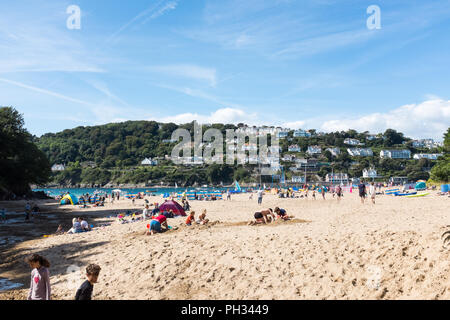 Les visiteurs profiter de la fin de l'été soleil sur une plage sur l'estuaire de Salcombe près de East Portlemouth dans South Hams, Devon Banque D'Images