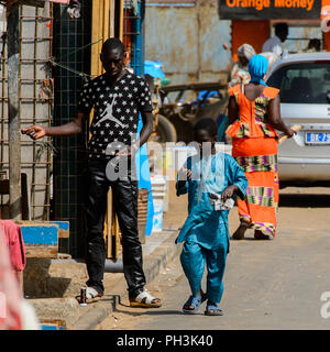 KAYAR, SÉNÉGAL - AVR 27, 2017 : petit garçon sénégalais non identifiés en costume bleu est titulaire d'un morceau de papier sur le marché local de Kayar, au Sénégal. Banque D'Images