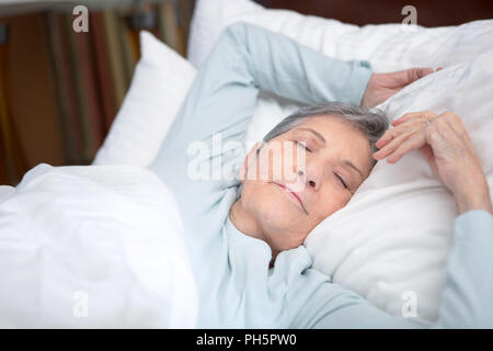 Femme âgée de passer une bonne nuit de sommeil. Banque D'Images